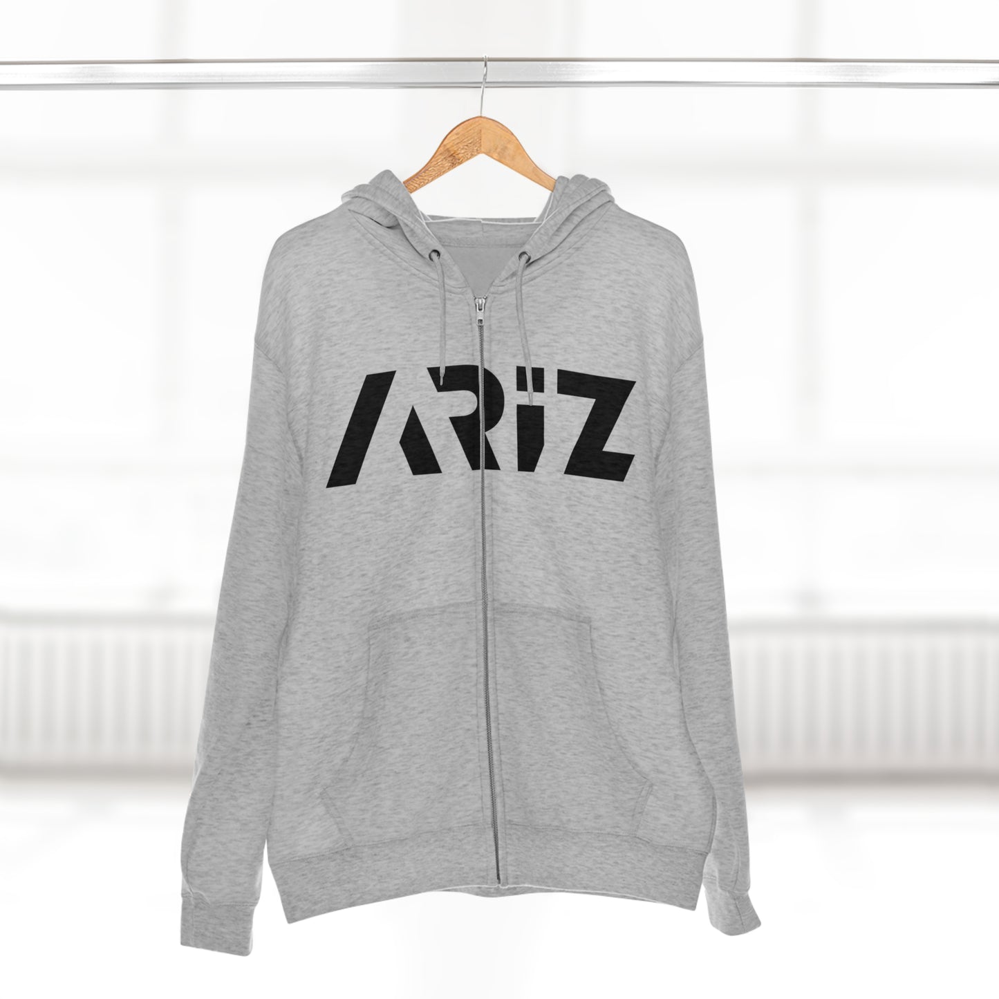 Front view of a grey hoodie featuring the ARIZ brand logo. Unisex design made from 100% cotton, proudly made in the USA.